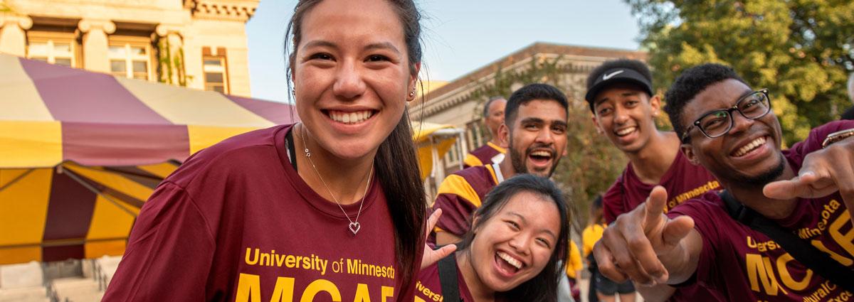 Students wearing maroon and gold during a welcome event on campus