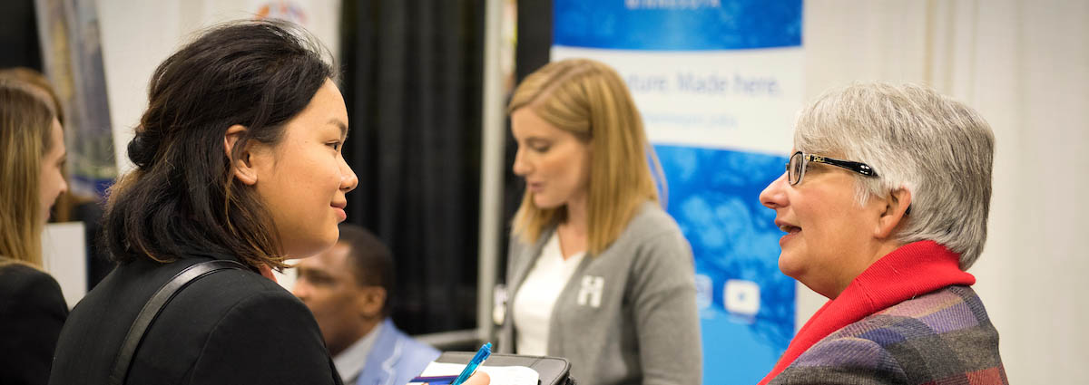 A student speaks with an employer at a career fair