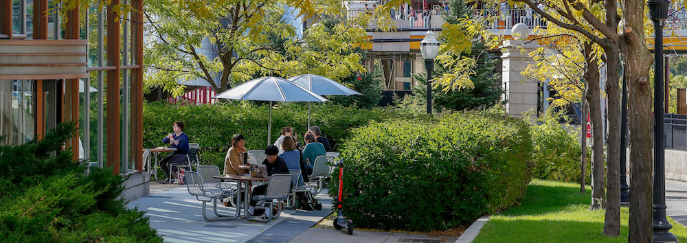 Students eating at a table on campus.