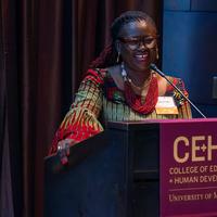 Millicent Adjei speaking behind a podium