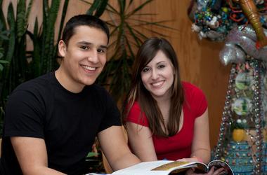 Two students smile at the camera
