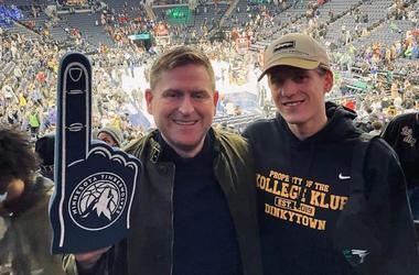 Bolli at a Timberwolves game with another person wearing a Timberwolves foam finger